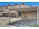 Carport featuring brick wall with door, desert landscaping and concrete surface at 3912 Palos Verdes St, Las Vegas, NV 89119