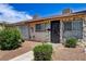 Townhome featuring a stone facade, security bars on windows, and low-maintenance landscaping at 3912 Palos Verdes St, Las Vegas, NV 89119
