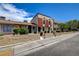 View of the townhome, landscaped yard, concrete block wall, and sidewalk at 3912 Palos Verdes St, Las Vegas, NV 89119