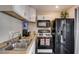 Kitchen features double sinks, modern appliances, white cabinets, and overhead lighting at 3912 Palos Verdes St, Las Vegas, NV 89119