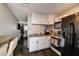 A view of the kitchen shows stainless steel double sinks, black appliances, and white cabinets at 3912 Palos Verdes St, Las Vegas, NV 89119