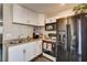 A view of the kitchen featuring modern appliances, double sinks, white cabinets, and a coffee maker at 3912 Palos Verdes St, Las Vegas, NV 89119