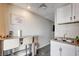 A view of the kitchen features stainless steel double sinks and a breakfast bar at 3912 Palos Verdes St, Las Vegas, NV 89119