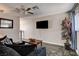 Comfortable living room with slate flooring, a ceiling fan, and a mounted television at 3912 Palos Verdes St, Las Vegas, NV 89119