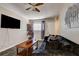 Warm and inviting living room features modern decor, ceiling fan, mounted television, and tile floors at 3912 Palos Verdes St, Las Vegas, NV 89119