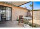 Back patio featuring metal framed windows, brick wall, furniture, and desert landscaping at 3912 Palos Verdes St, Las Vegas, NV 89119