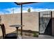 Outdoor patio featuring brick wall, gated entrance, and table with chair at 3912 Palos Verdes St, Las Vegas, NV 89119