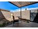 Outdoor patio featuring brick wall, gated entrance, and table with chair at 3912 Palos Verdes St, Las Vegas, NV 89119