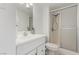 A clean and modern bathroom with glass-enclosed shower, toilet, and vanity with sink and mirror at 3930 University Center Dr # 208, Las Vegas, NV 89119