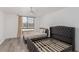 Well-lit bedroom boasts two beds, neutral walls, and large window with vertical blinds at 3930 University Center Dr # 208, Las Vegas, NV 89119