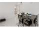 Clean, bright dining area boasts gray dining set, white floors, and access to updated bathroom at 3930 University Center Dr # 208, Las Vegas, NV 89119