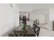 Bright dining space featuring a gray wood dining table and open view to kitchen with bar seating at 3930 University Center Dr # 208, Las Vegas, NV 89119