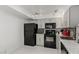 Well-lit kitchen with gray cabinets, black appliances, and plenty of counter space at 3930 University Center Dr # 208, Las Vegas, NV 89119