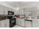 Bright kitchen featuring modern appliances, marble countertops and gray wood cabinetry at 3930 University Center Dr # 208, Las Vegas, NV 89119
