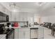 Charming kitchen features gray cabinets, sleek black appliances, and marble countertops at 3930 University Center Dr # 208, Las Vegas, NV 89119