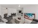 Bright living room with tile floors, neutral walls, comfortable seating and an adjacent kitchen at 3930 University Center Dr # 208, Las Vegas, NV 89119