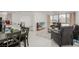 Bright and open living room with kitchen, tile floors, neutral walls and comfortable seating at 3930 University Center Dr # 208, Las Vegas, NV 89119