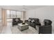 Bright living room with tile floors, neutral walls, comfortable seating and large windows at 3930 University Center Dr # 208, Las Vegas, NV 89119