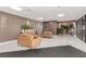 Relaxing lobby with modern seating, plants, light tile flooring, wood slat wall and recessed lighting at 3930 University Center Dr # 208, Las Vegas, NV 89119