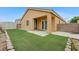 Inviting backyard features a covered patio and maintenance-free artificial turf at 4078 Blue Manor Ln, North Las Vegas, NV 89032