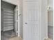 Bedroom hallway showing a walk-in closet with custom shelves, a linen closet and carpet flooring at 4078 Blue Manor Ln, North Las Vegas, NV 89032