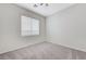 Neutral bedroom with carpeting, fan, and bright natural lighting at 4078 Blue Manor Ln, North Las Vegas, NV 89032