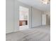 Open bedroom leading to bathroom with grey carpet, neutral walls, and bright lighting at 4078 Blue Manor Ln, North Las Vegas, NV 89032