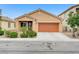 Single story home featuring a desert landscape, two car garage, and a tiled roof at 4078 Blue Manor Ln, North Las Vegas, NV 89032