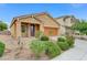 Single story home featuring a desert landscape, two car garage, and a tiled roof at 4078 Blue Manor Ln, North Las Vegas, NV 89032