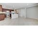 Open kitchen with white appliances and dark wood cabinetry at 4078 Blue Manor Ln, North Las Vegas, NV 89032