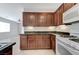 Kitchen showcasing dark wood cabinets and tiled floors at 4078 Blue Manor Ln, North Las Vegas, NV 89032