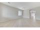 Spacious living room featuring tile flooring, a ceiling fan, and natural light at 4078 Blue Manor Ln, North Las Vegas, NV 89032