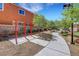 A sidewalk and outdoor fitness area surrounded by trees and greenery enhance the community's appeal at 4078 Blue Manor Ln, North Las Vegas, NV 89032