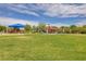 A playground on a sunny day with colorful shades, lush greenery, and plenty of space to enjoy at 4078 Blue Manor Ln, North Las Vegas, NV 89032