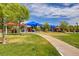 A vibrant playground features picnic tables, green spaces and colorful shades, perfect for outdoor fun at 4078 Blue Manor Ln, North Las Vegas, NV 89032
