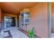 A covered patio provides entry into a home featuring a secure metal door and a window projecting outward from the wall at 413 N Lamb Blvd # F, Las Vegas, NV 89110