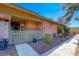 Exterior view of the front entrance with peach siding, light grey fence, and partial view of unit number at 413 N Lamb Blvd # F, Las Vegas, NV 89110