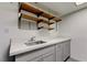 Functional laundry room featuring a utility sink, ample counter space, and convenient open shelving at 413 N Lamb Blvd # F, Las Vegas, NV 89110