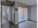 Bright living room area featuring modern flooring, neutral gray walls, and access to the outside patio at 413 N Lamb Blvd # F, Las Vegas, NV 89110