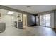 Open-concept living area with modern gray walls, wood-look flooring, and a sliding glass door to the outside at 413 N Lamb Blvd # F, Las Vegas, NV 89110