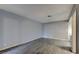 The living area features modern wood flooring, light gray walls, and an open doorway to the hallway at 413 N Lamb Blvd # F, Las Vegas, NV 89110