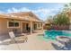 Wonderful backyard featuring a pool, covered patio, BBQ, and lush tropical landscaping at 4329 Skimmers Ct, North Las Vegas, NV 89084