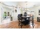 Bright dining area with modern light fixture and a dark wood table set for four at 4329 Skimmers Ct, North Las Vegas, NV 89084