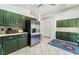 Spacious kitchen with stainless steel refrigerator, and olive-green cabinets at 4329 Skimmers Ct, North Las Vegas, NV 89084