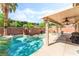Sparkling pool featuring a built-in spa and lush tropical landscaping at 4329 Skimmers Ct, North Las Vegas, NV 89084