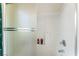 Shower featuring frosted glass door and built-in shelves with toiletries at 4329 Skimmers Ct, North Las Vegas, NV 89084