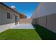 Well-maintained backyard with artificial grass and a concrete patio at 4481 Faberge Ave, Las Vegas, NV 89115
