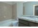 Bathroom featuring granite countertops, updated cabinets and sink, and tiled bath and shower combo at 4481 Faberge Ave, Las Vegas, NV 89115