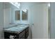 This bathroom includes vanity with a granite countertop and a modern mirror at 4481 Faberge Ave, Las Vegas, NV 89115
