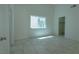 This bedroom features tile floors, a window, and neutral walls at 4481 Faberge Ave, Las Vegas, NV 89115